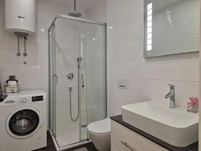 a bathroom with a shower and a toilet and a sink at A Blok Modern Apartment in Belgrade