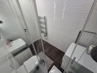 a bathroom with a shower and a toilet and a sink at A Blok Modern Apartment in Belgrade