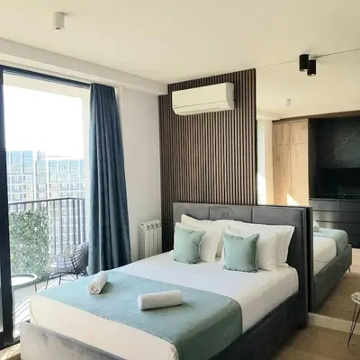a bedroom with two beds and a large window at Beograd na vodi - Belgrade Waterfront BW apartment in Belgrade