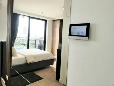 a bedroom with a bed and a tv on a wall at Beograd na vodi - Belgrade Waterfront BW apartment in Belgrade