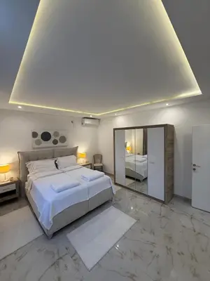 a bedroom with a large bed and a mirror at Beige Harmony in Smederevo