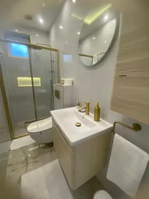 a bathroom with a sink and a toilet and a mirror at Beige Harmony in Smederevo