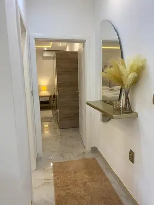 a hallway with a mirror and a hallway with a room at Beige Harmony in Smederevo