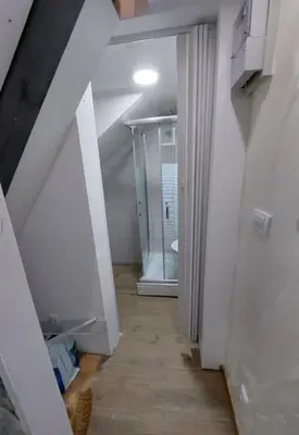 an attic hallway with a hallway leading to a bathroom at Radojkovic Apartman in Belgrade