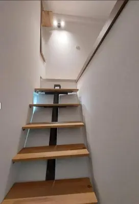 a stairway with wooden shelves in a room at Radojkovic Apartman in Belgrade