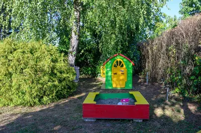 a small play house in a yard with trees at Kings Hill - Family Retreat in Sremski Karlovci