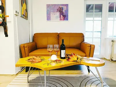 a living room with a couch and a table with wine glasses at Kings Hill - Family Retreat in Sremski Karlovci