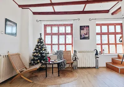 a living room with a christmas tree and chairs at Kings Hill - Family Retreat in Sremski Karlovci