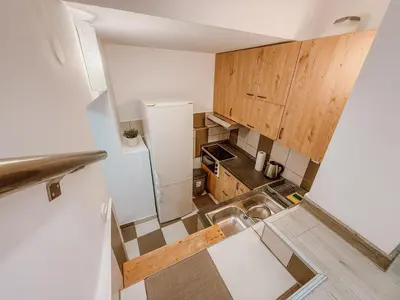 a small kitchen with a sink and a refrigerator at Central Spot Belgrade - ART residence in Belgrade