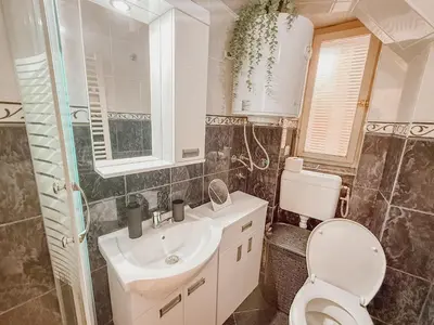 a bathroom with a toilet and a sink at Central Spot Belgrade - ART residence in Belgrade