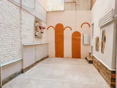an empty alley with orange and white walls at Central Spot Belgrade - ART residence in Belgrade
