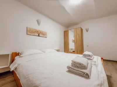 a bedroom with a white bed with towels on it at Central Spot Belgrade - ART residence in Belgrade