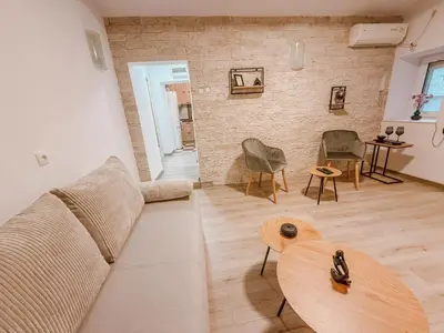 a living room with a couch and a table at Central Spot Belgrade - ART residence in Belgrade