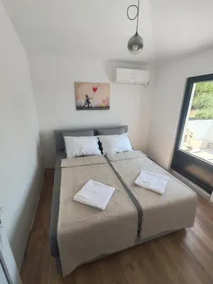 a bedroom with a bed with two towels on it at Villa Kally Fruska Gora in Velika Remeta