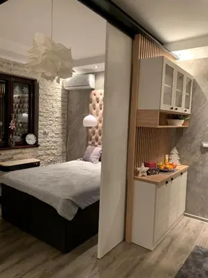 a bedroom with a large bed in a room at Apartman M&A in Inđija