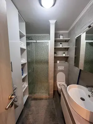 a bathroom with a shower and a toilet and a sink at Apartman M&A in Inđija
