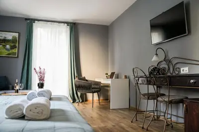a bedroom with a bed and a desk and a window at Boutique Hotel Aviator in Belgrade