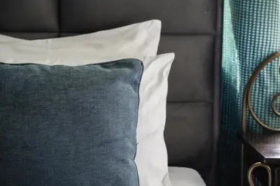 a black and white pillow sitting on a bed at Boutique Hotel Aviator in Belgrade