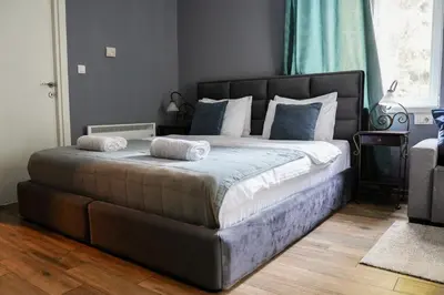 a bedroom with a large bed with towels on it at Boutique Hotel Aviator in Belgrade