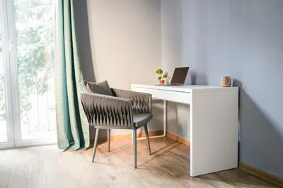 a desk with a laptop and a chair next to a window at Boutique Hotel Aviator in Belgrade