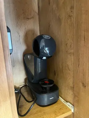 a black coffee maker sitting on a wooden shelf at Forest Nook FREE GARAGE in Belgrade
