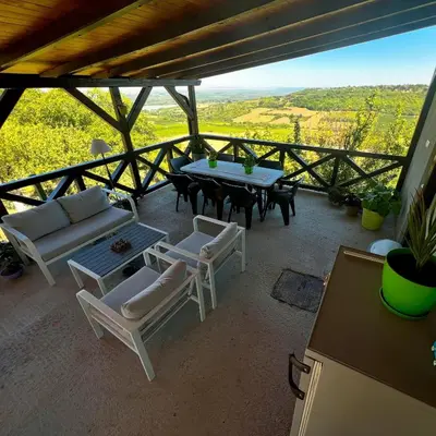 a patio with a table and chairs and a view at Pokito House on the Hill in Sremski Karlovci