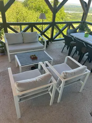 a patio with a couch and chairs and a table at Pokito House on the Hill in Sremski Karlovci