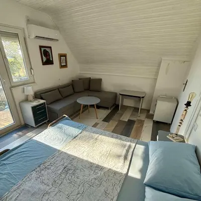 a living room with a bed and a couch at Pokito House on the Hill in Sremski Karlovci