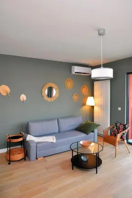 a living room with a blue couch and a table at Belgrade Waterfront Heaven! in Belgrade