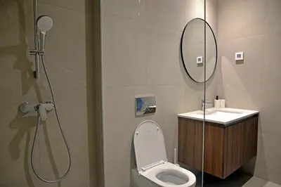 a bathroom with a shower and a toilet and a sink at Belgrade Waterfront Heaven! in Belgrade