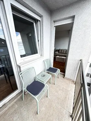 two chairs and a table on a balcony at Limpio Apartman 2 in Belgrade