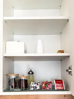 a shelf in a kitchen with food items on it at Limpio Apartman 2 in Belgrade