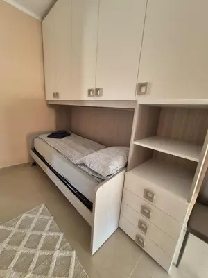 a small bedroom with a bed and cabinets at Rio Apartmani Ub 2 in Ub