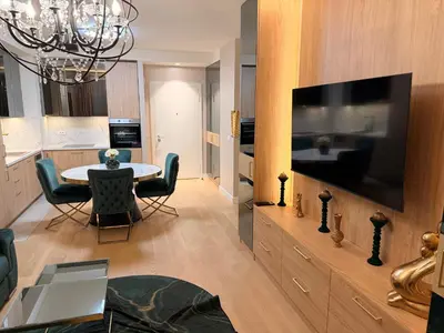 a living room with a table and a large television at BW Loft Apartments FREE GARAGE Fast Wi-Fi in Belgrade