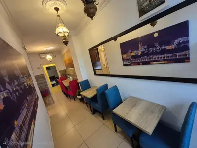 a restaurant with a wooden table and blue chairs at Authentic Belgrade Centre Hostel - Only Private Rooms in Belgrade
