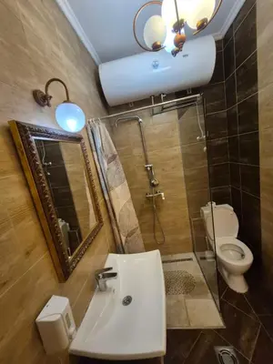 a bathroom with a sink and a toilet and a mirror at Authentic Belgrade Centre Hostel - Only Private Rooms in Belgrade