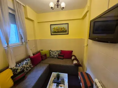 a small living room with a couch and a tv at Authentic Belgrade Centre Hostel - Only Private Rooms in Belgrade