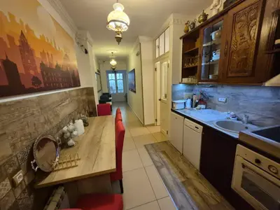 a kitchen with a sink and a wooden table at Authentic Belgrade Centre Hostel - Only Private Rooms in Belgrade