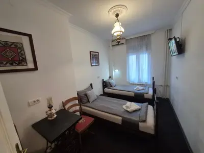 a small room with two beds and a table at Authentic Belgrade Centre Hostel - Only Private Rooms in Belgrade