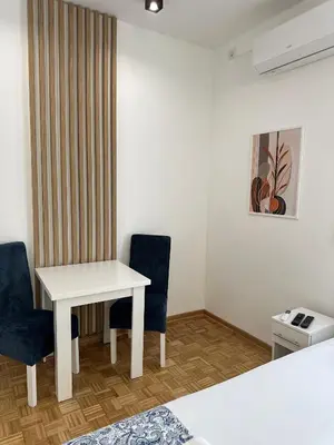 a room with a white table and two chairs at URBAN Suites in Belgrade