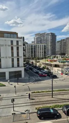 a city street with cars parked in a parking lot at URBAN Suites in Belgrade