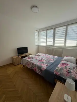 a bedroom with a bed and a television in it at MT Apartman in Belgrade