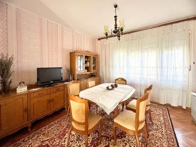 a dining room with a table and chairs and a television at Kuća za odmor ,, Bundevica,,
