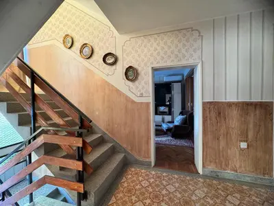 a staircase in a house with clocks on the wall at Kuća za odmor ,, Bundevica,,