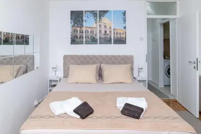a bedroom with a bed with two towels on it at Apartman Horizont in Arandjelovac