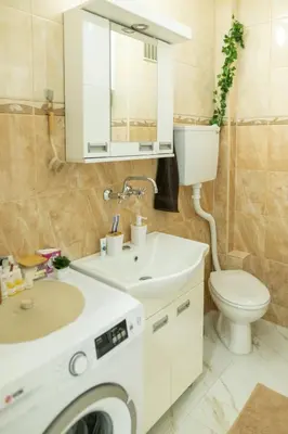 a bathroom with a white sink and a toilet at Apartman Horizont in Arandjelovac
