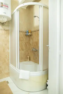 a bathroom with a shower with a bath tub at Apartman Horizont in Arandjelovac