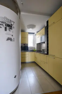 a large kitchen with yellow cabinets and a window at Apartment Angelo in Belgrade