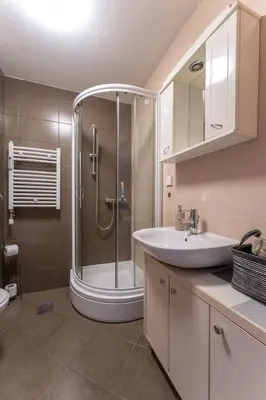 a bathroom with a shower and a sink and a tub at Apartment Angelo in Belgrade