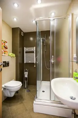 a bathroom with a shower and a toilet and a sink at Apartment Angelo in Belgrade